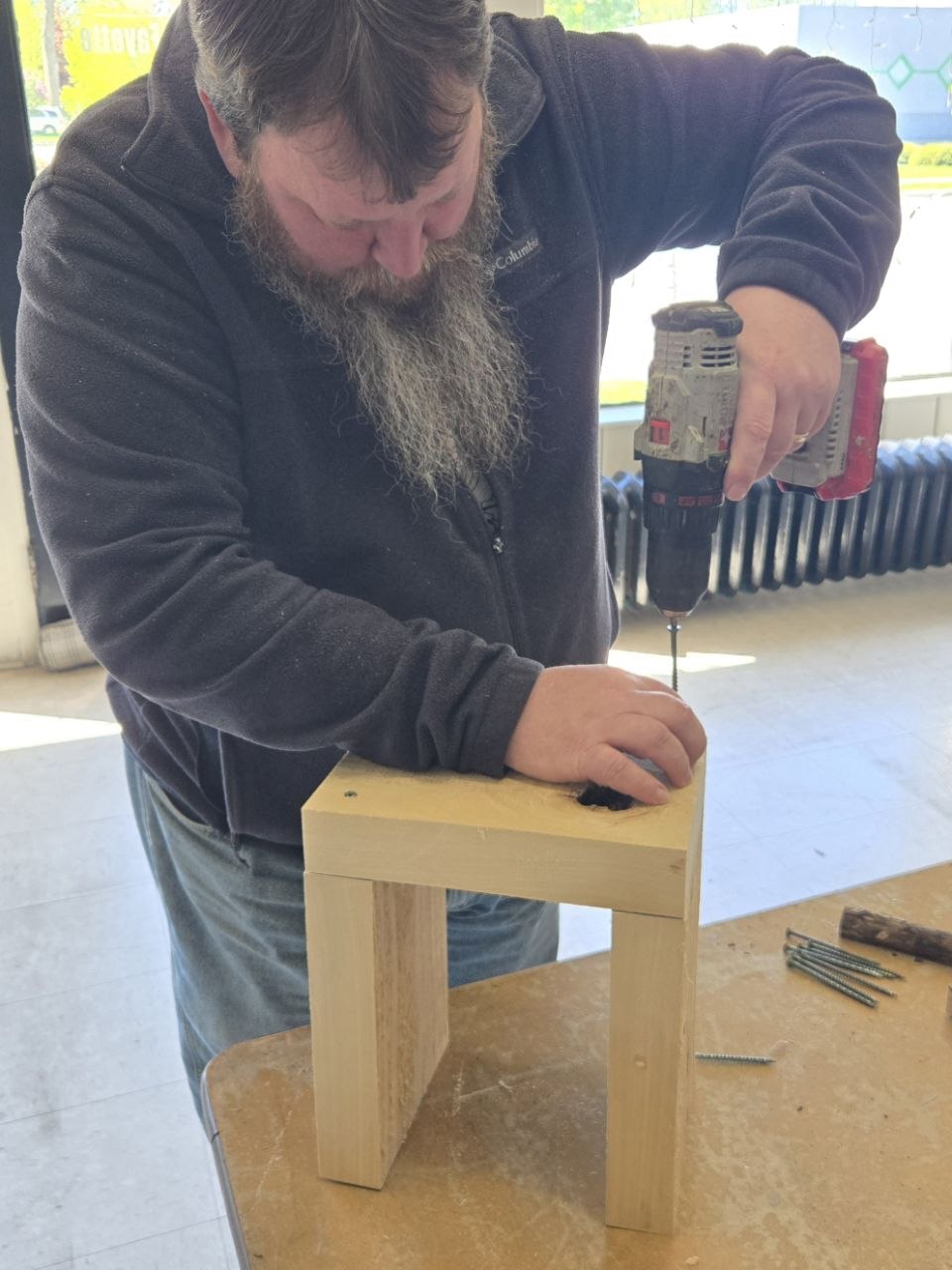 Top-down look at the rustic bee hotel shell and parts laid out on the table