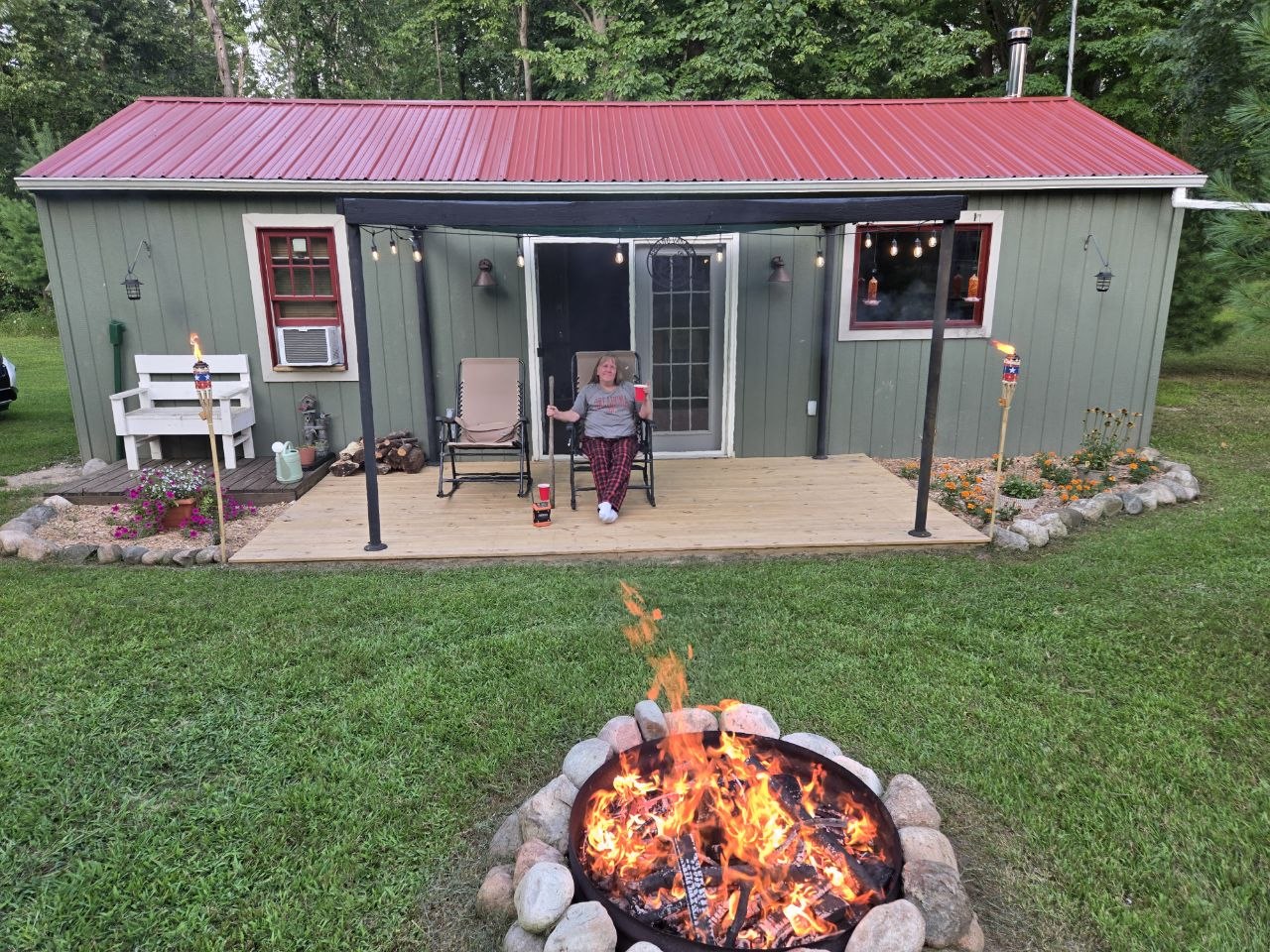 Cabin and fire scene at dusk