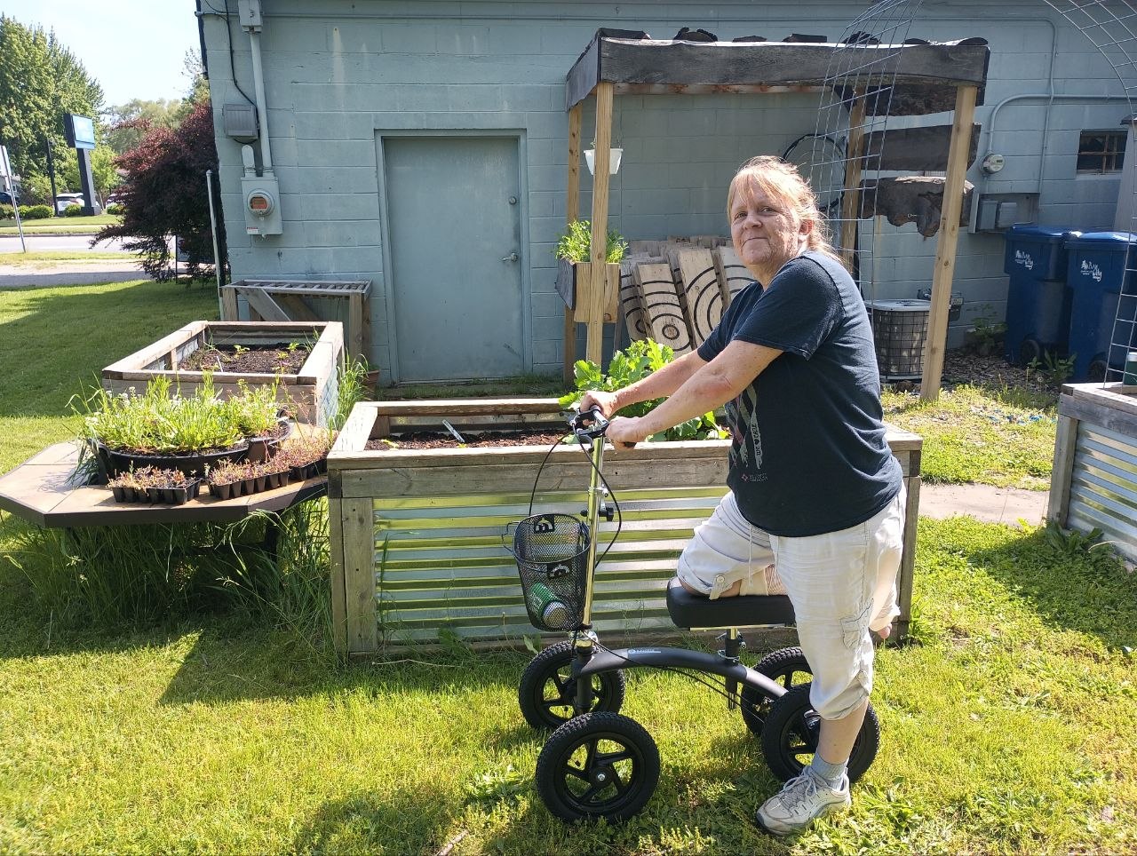Vanessa using a little scooter around the garden after breaking her ankle