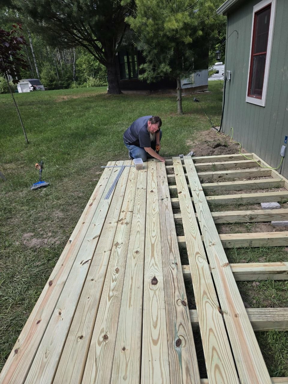 Half-finished deck with boards going down during the hard but satisfying middle stage of the build