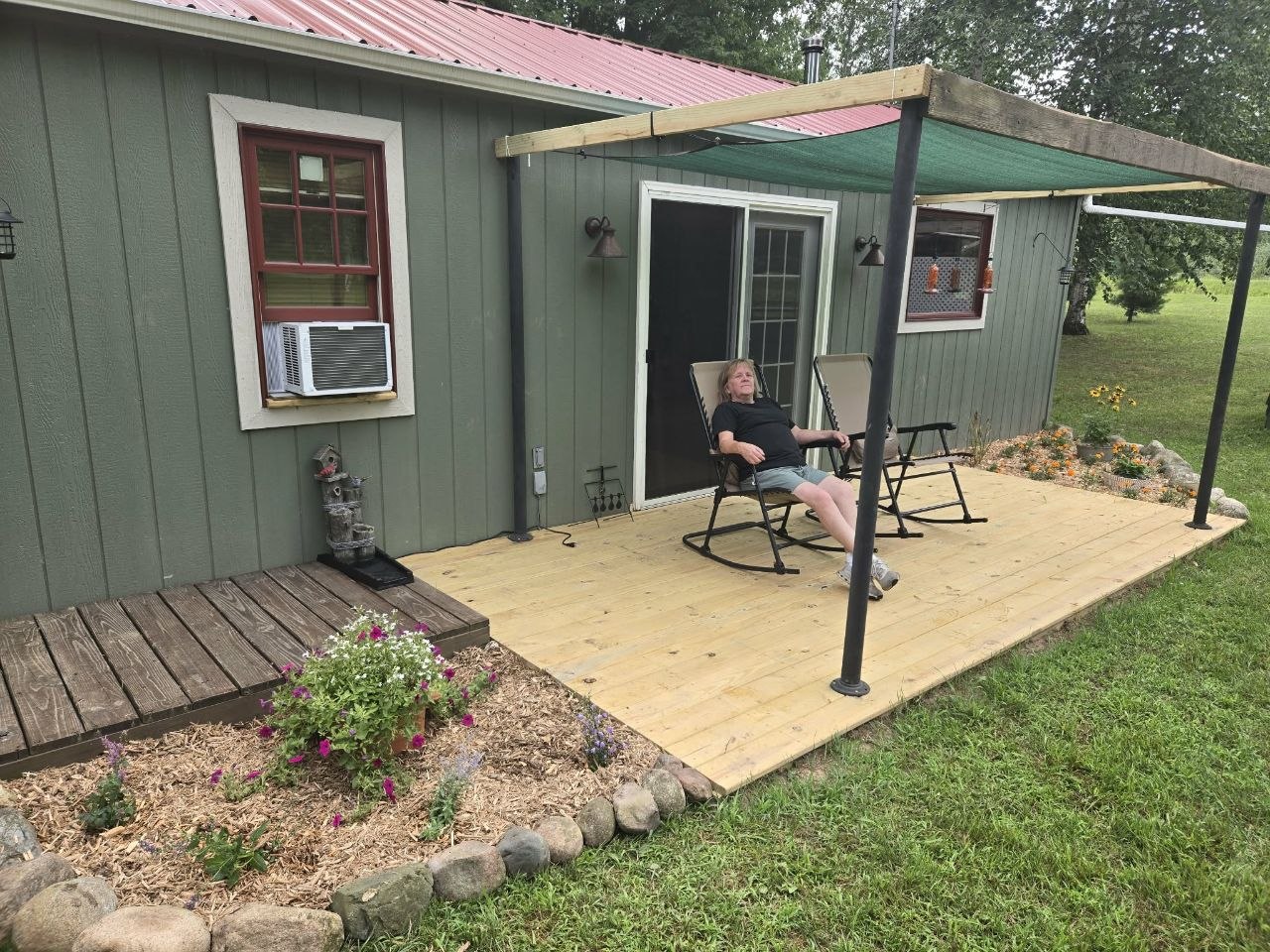 Deck with the new sunshade up, making the space more usable in the hot July sun