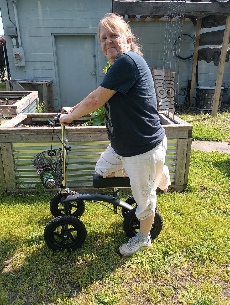 Vanessa using a knee scooter after breaking her ankle near the cabin raised beds