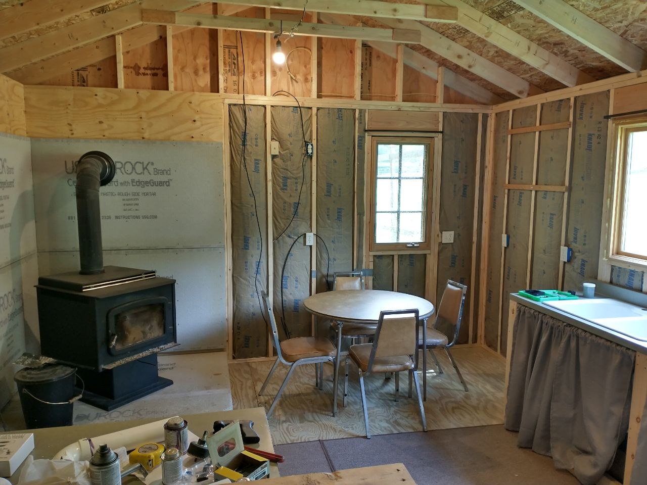 Very early unfinished cabin interior with improvised setup
