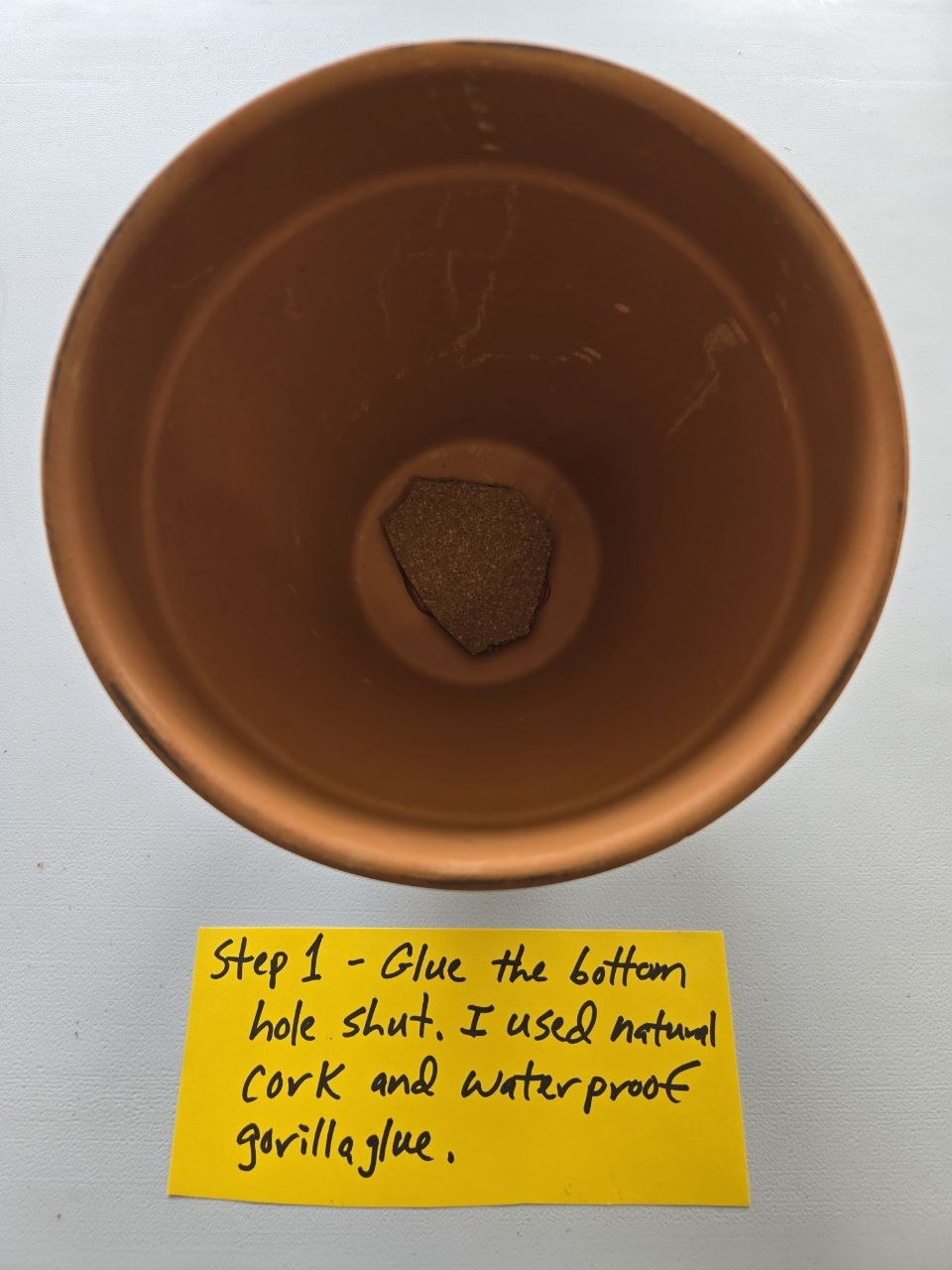 Sealing the hole in the bottom of one terra cotta pot for a simple olla